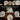 A lit cabinet of floral bone china plates, cups and a teapot